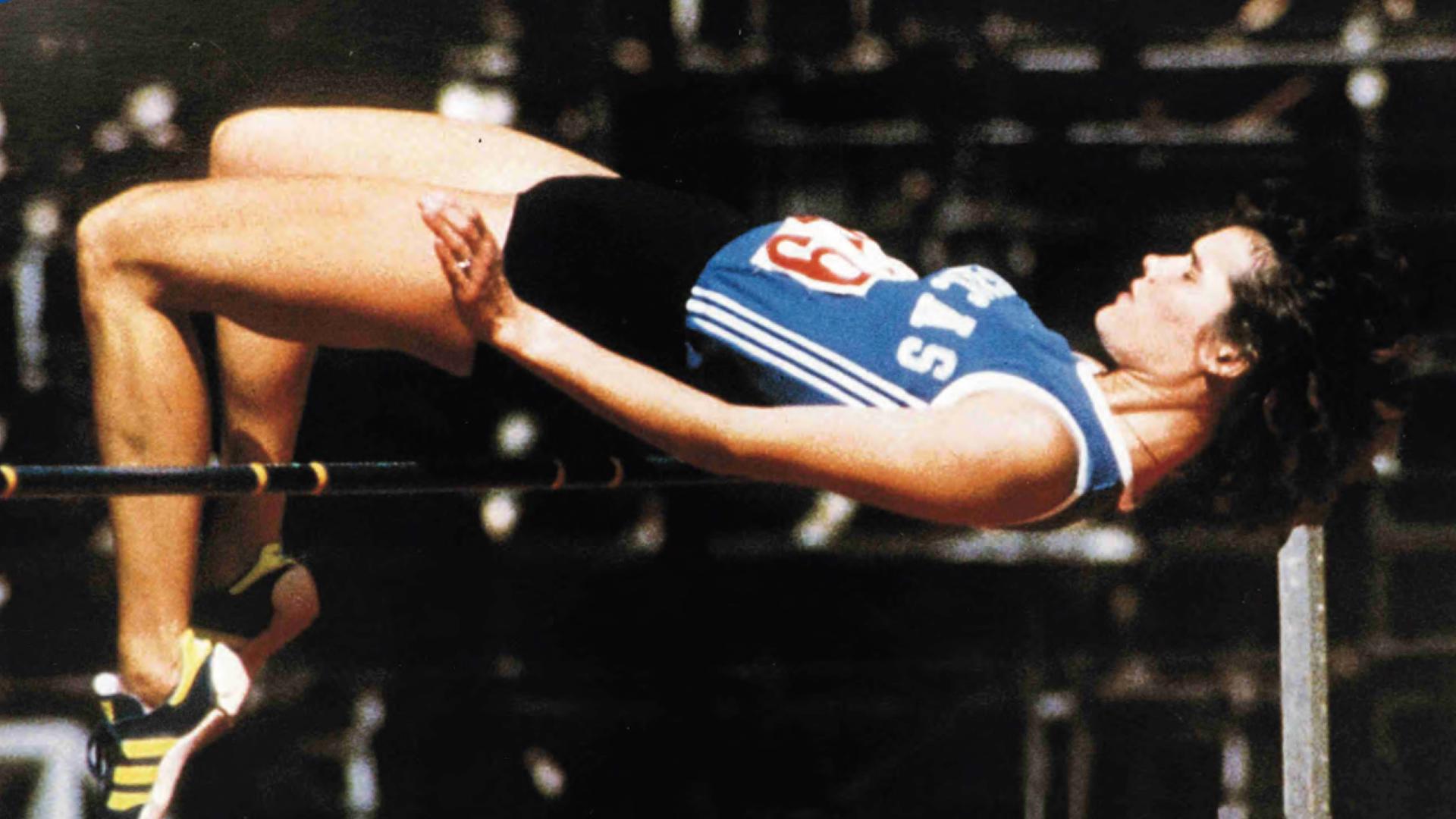 Debbie Brill performs her signature "Brill Bend" over a high jump pole.